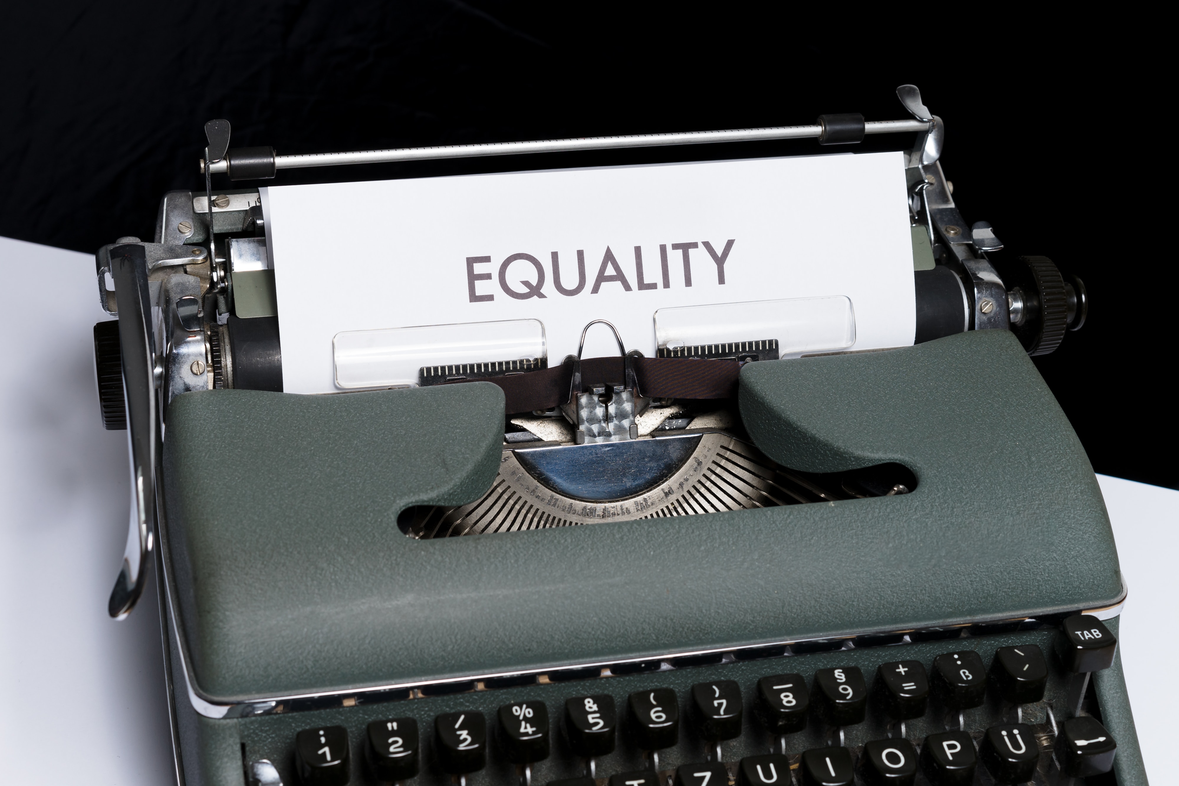 Typewriter with paper with text "equality"