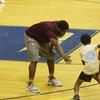 Coach directing children basketball players