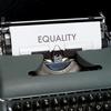 Typewriter with paper with text "equality"